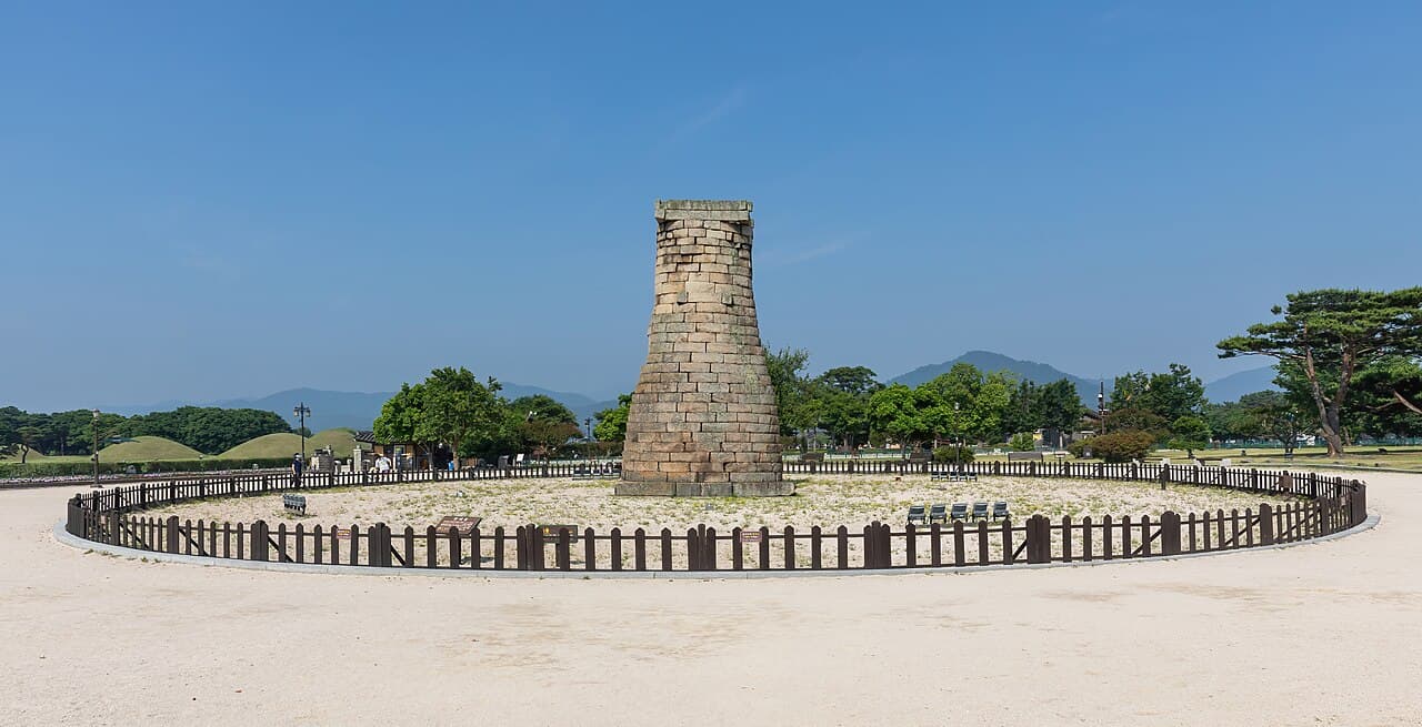 Cheomseongdae observatory, a bottle-shaped stone tower, under a blue sky in Gyeongju.