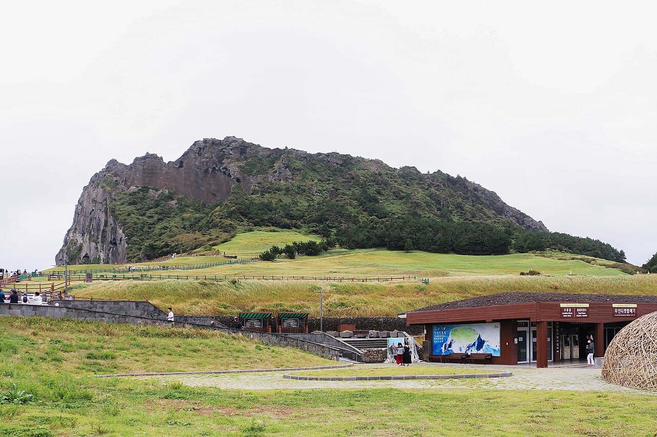 The volcanic tuff cone of Seongsan Ilchulbong rising from the Jeju coastline.